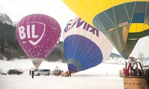 Hot air balloons inflating on snow.