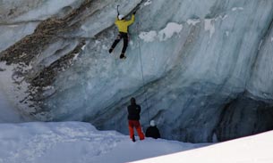 People ice climbing on a glacier.