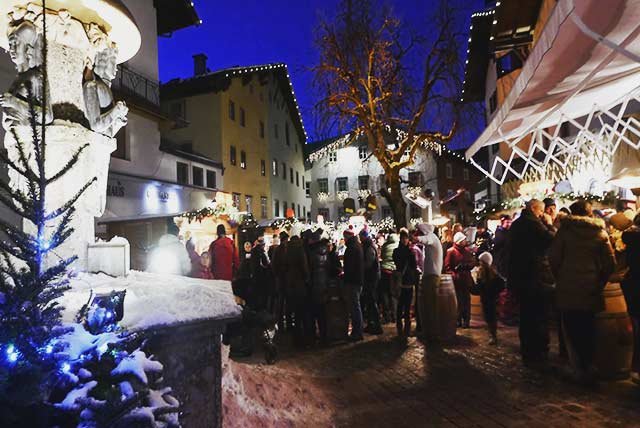 People standing in a Christmas market at night