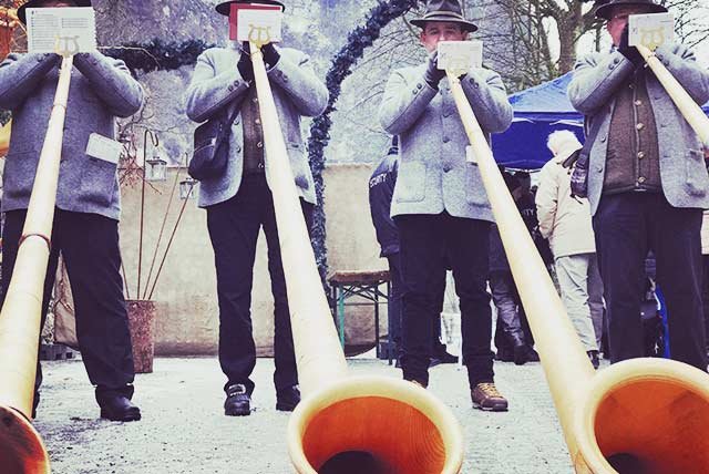 Musicians playing horns at a Christmas market