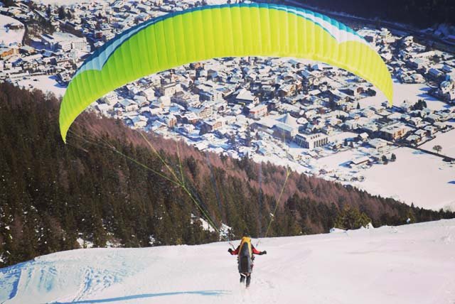 Paraglider about to get airborne on a snowy slope