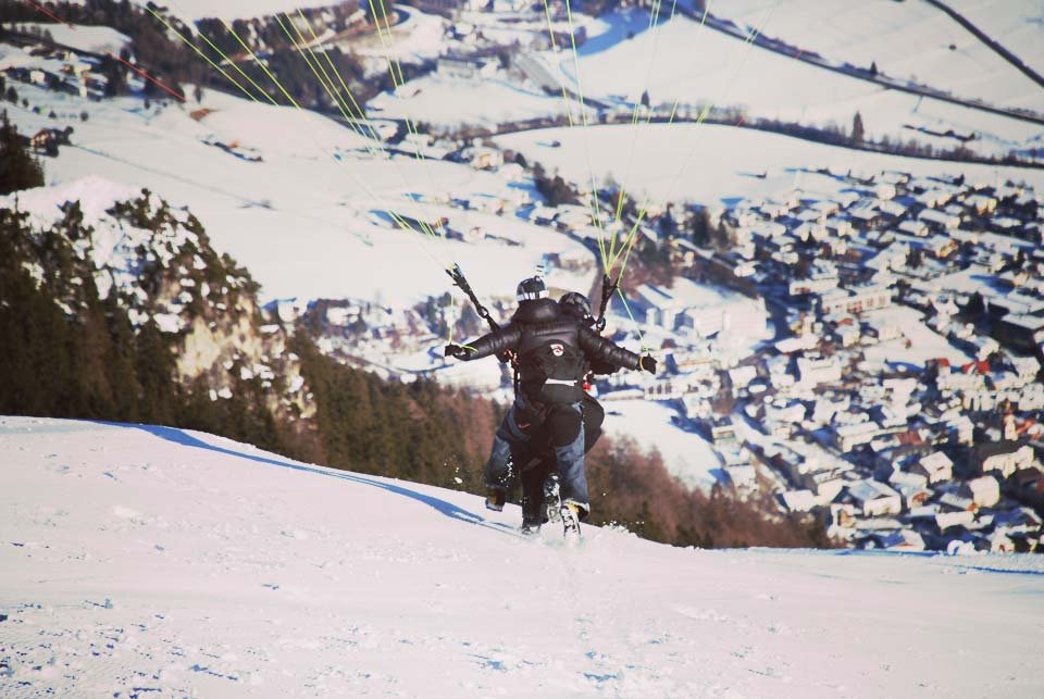 Paraglider about to get airborne on a snowy slope