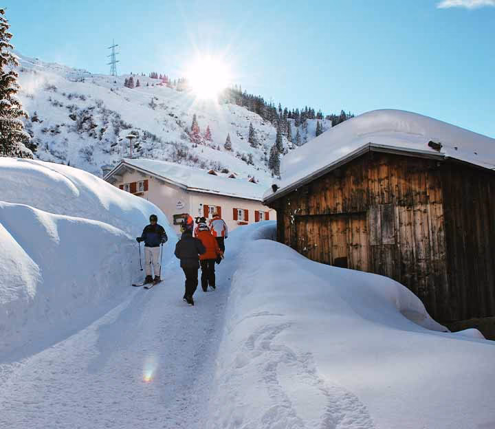 People walking down a snowy path